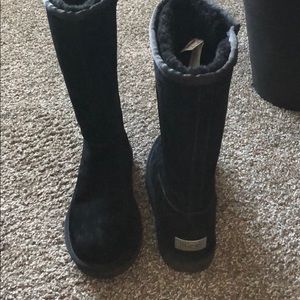 Black Tall Ugg boots with zipper and metal logo